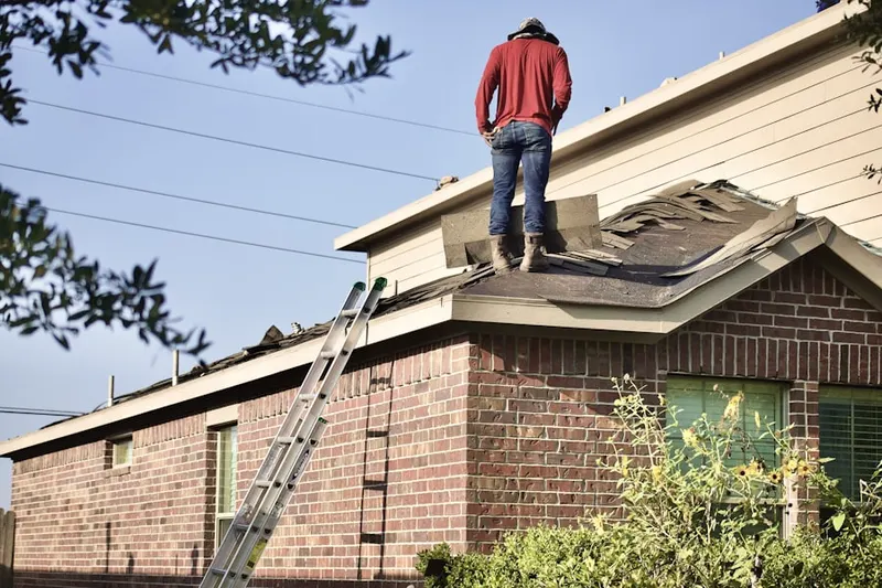 Professional roofer working on a residential roof in Meadow Village